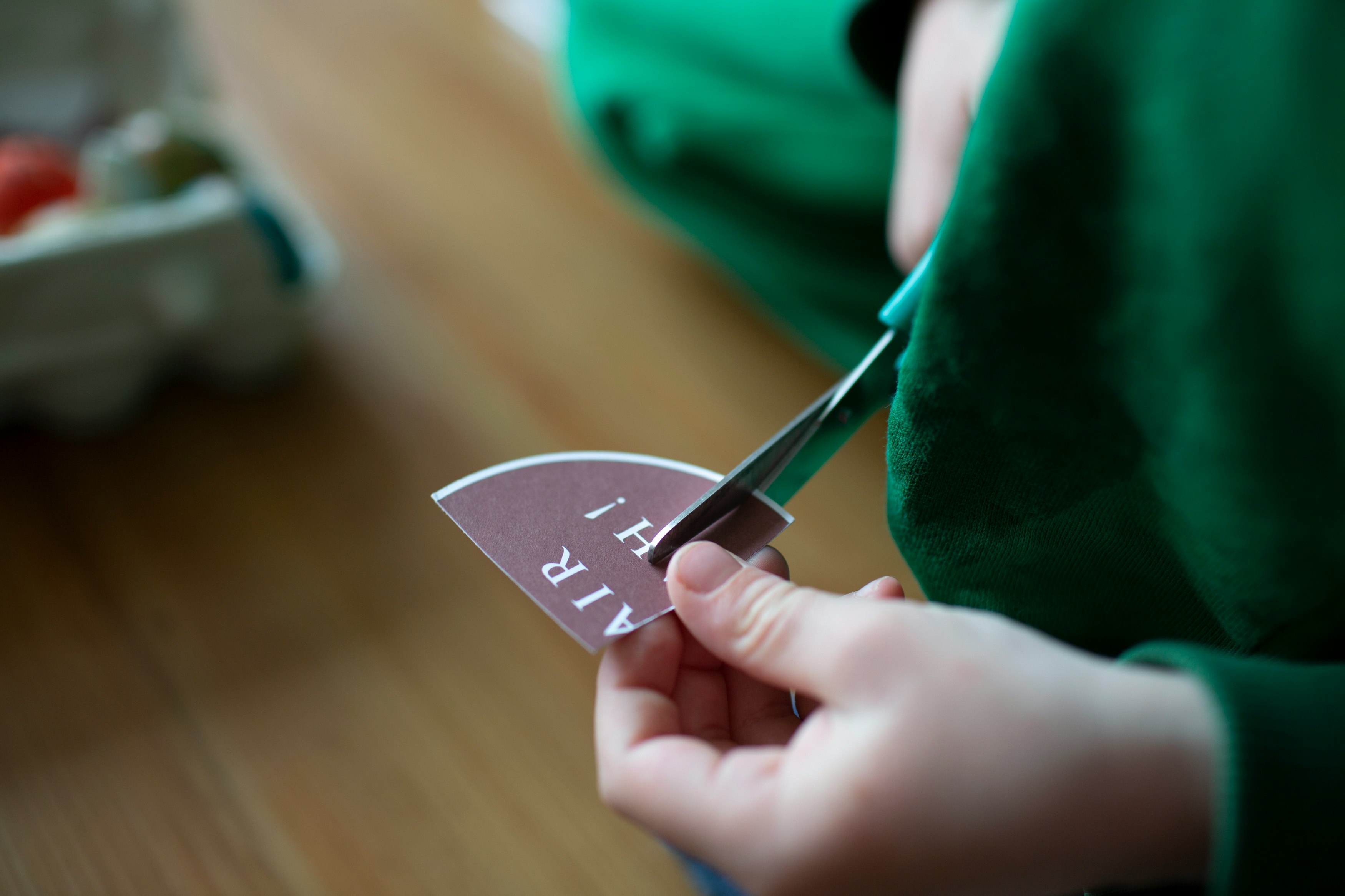 person holding gray and black heart ornament